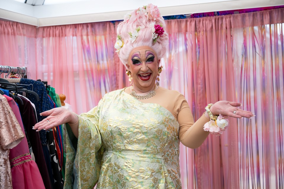 Mark Benton as Mam in a green dress and pink wig.