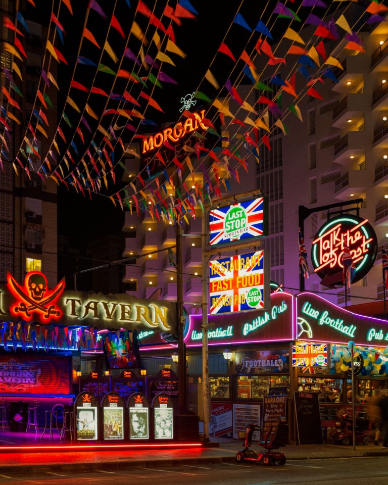 Night view of illuminated bars and pubs in Benidorm.