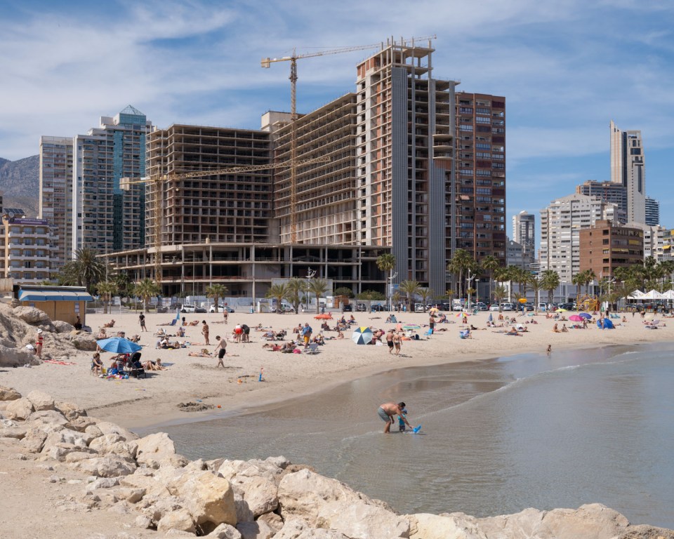 Benidorm beach with high-rise buildings under construction.
