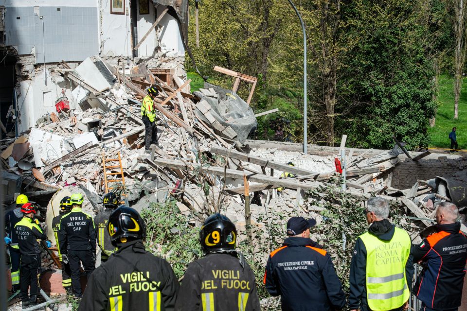 Collapsed building after gas explosion; rescue workers on scene.