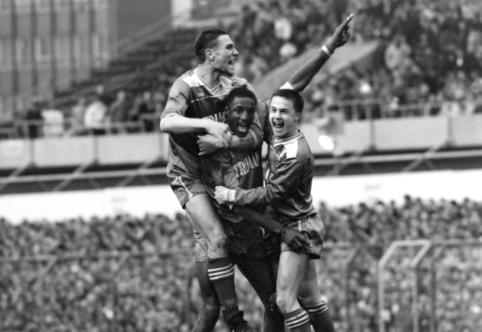 Soccer players celebrating a goal.