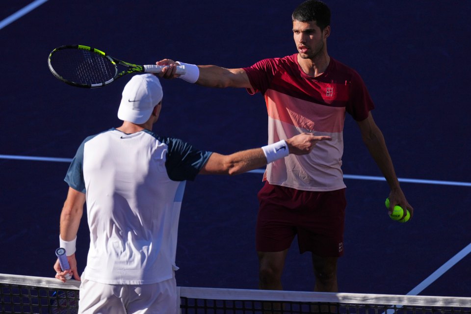 Carlos Alcaraz of Spain and Jack Draper of Great Britain disputing a call during a tennis match.