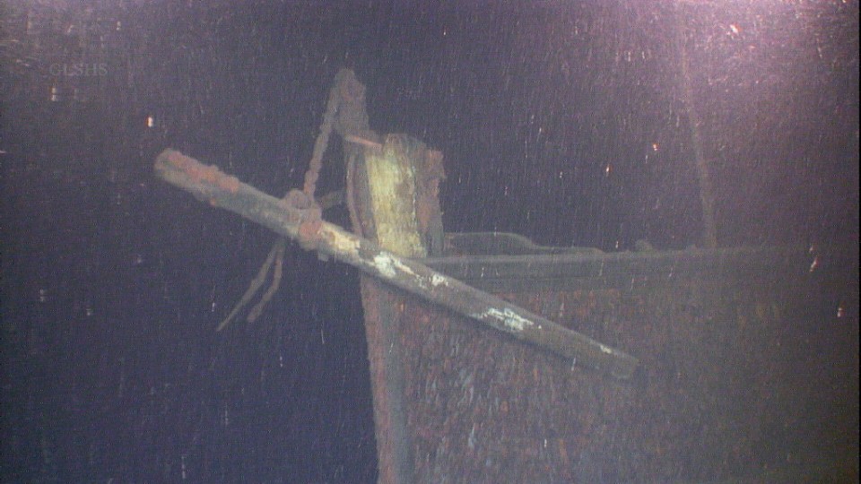 Underwater image of the rusted steering post from the Western Reserve shipwreck.