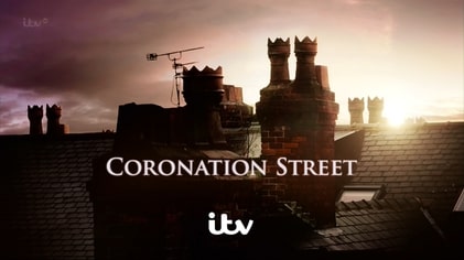 Coronation Street title card with rooftops at sunset.