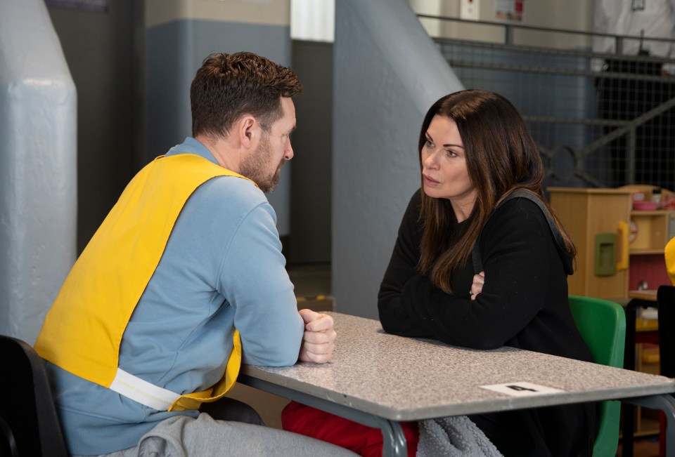 A woman visits a man in prison.