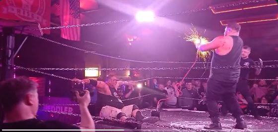 A deathmatch wrestling event where a wrestler electrocutes his father.