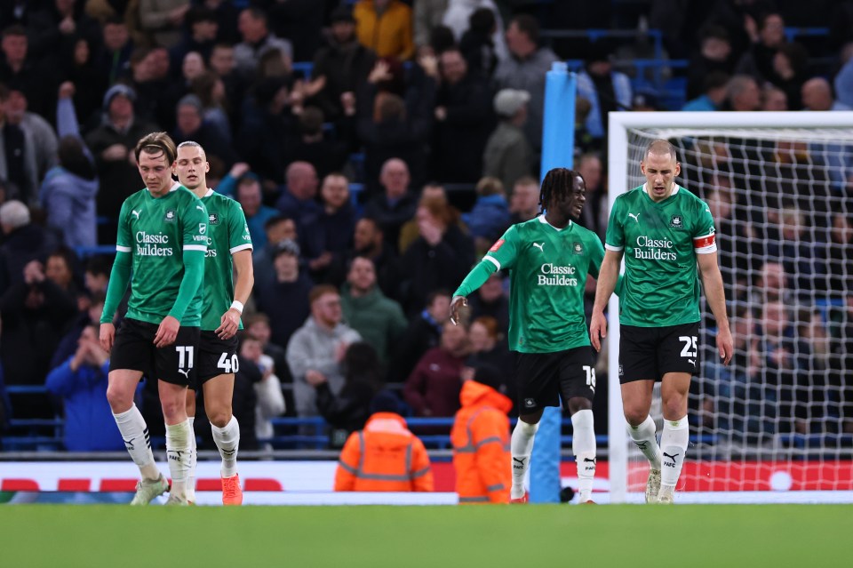 Dejected Plymouth Argyle soccer players after conceding a goal.