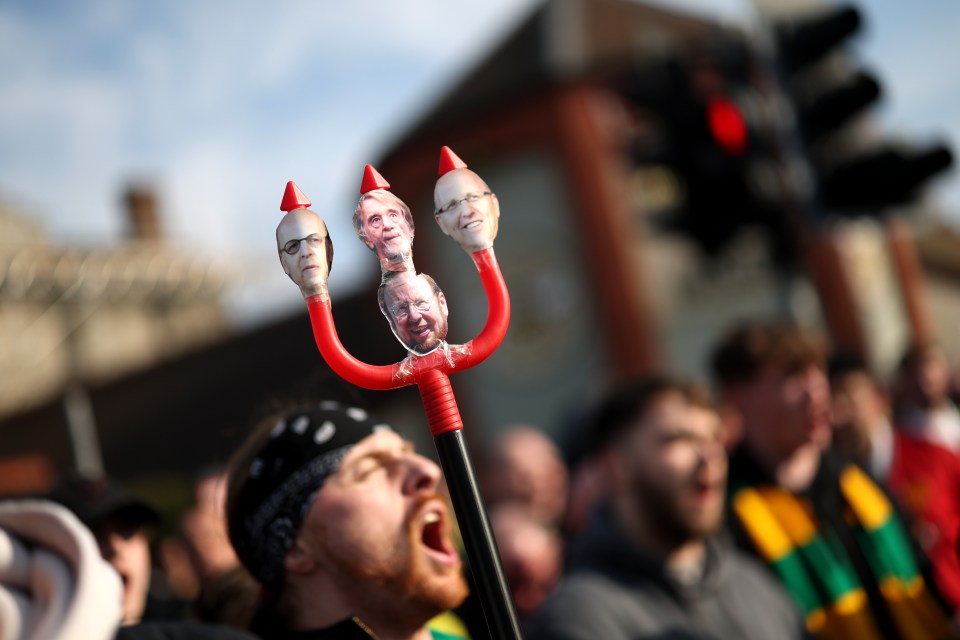 Pitchfork with photos of the Glazer family taped to it at a Manchester United protest.