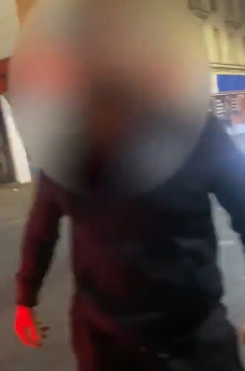 Blurry image of a person walking.