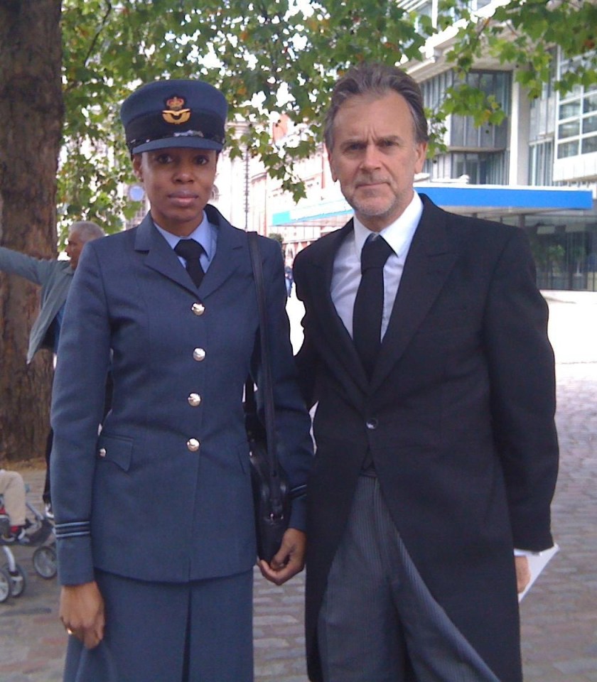 Photo of a woman in a military uniform and a man in a suit.