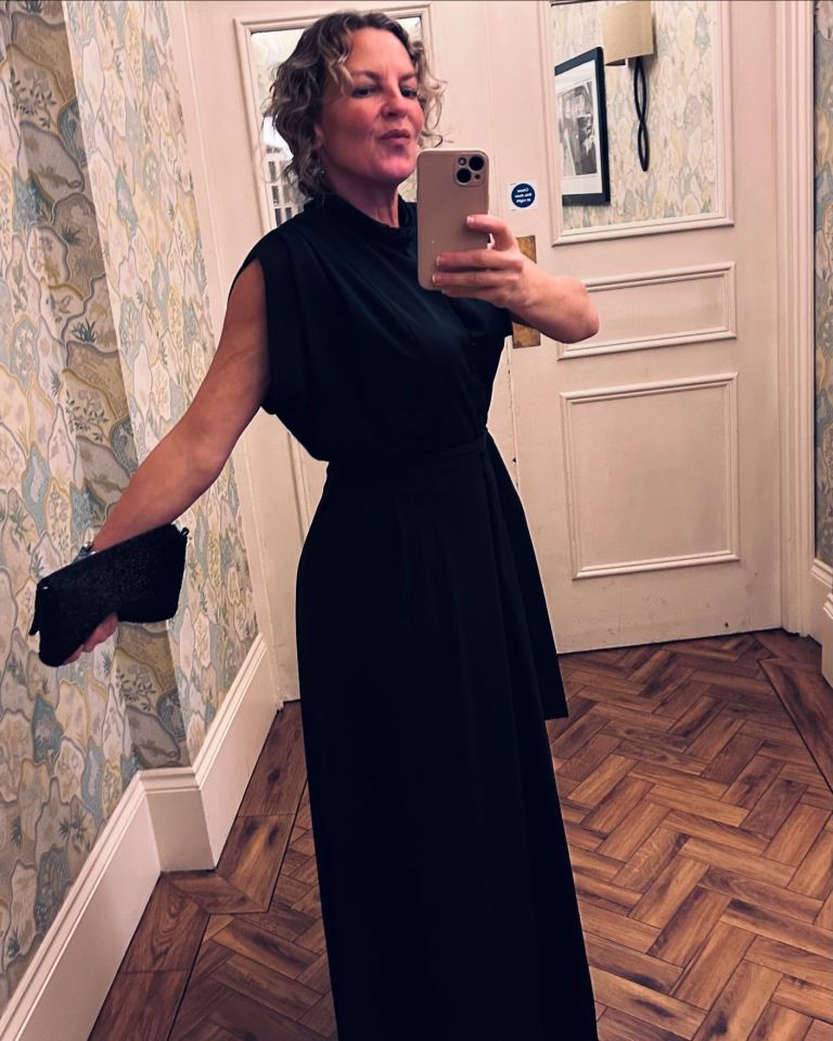 Lorraine Stanley in a black dress taking a selfie.