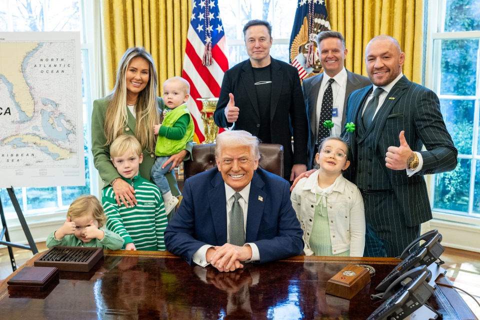 Group photo of Donald Trump with Elon Musk, Conor McGregor, and their families in the Oval Office.
