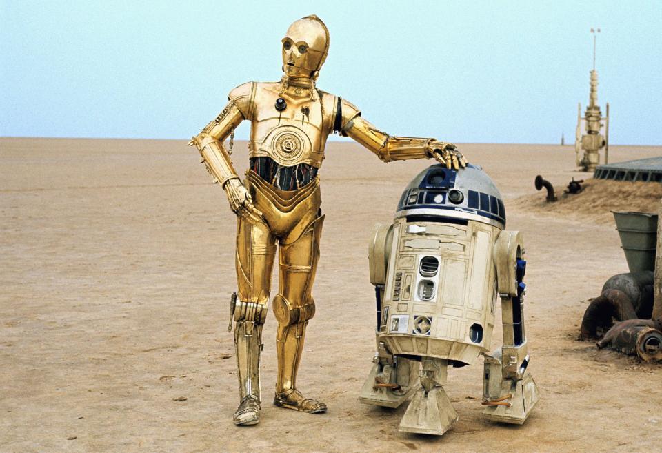 C-3PO and R2-D2 in a desert landscape.