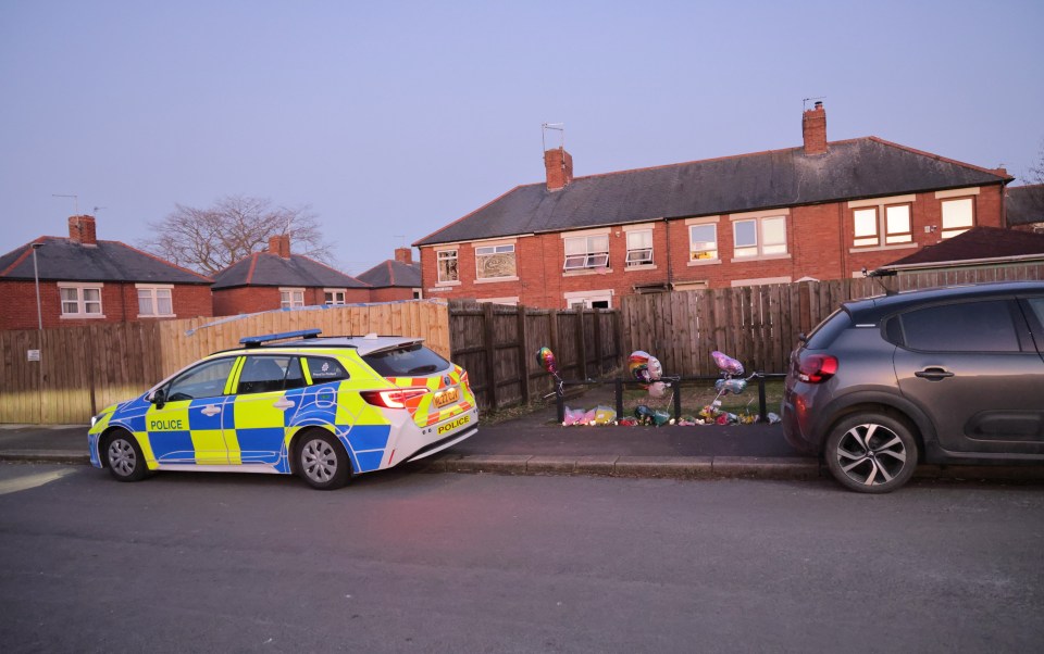 Police car outside house where a four-year-old girl died in a fire.