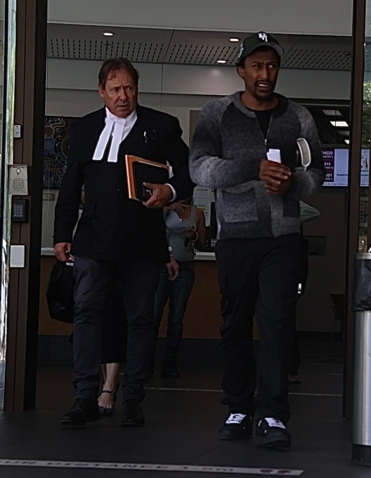 Yung Filly leaving a courthouse with his lawyer.
