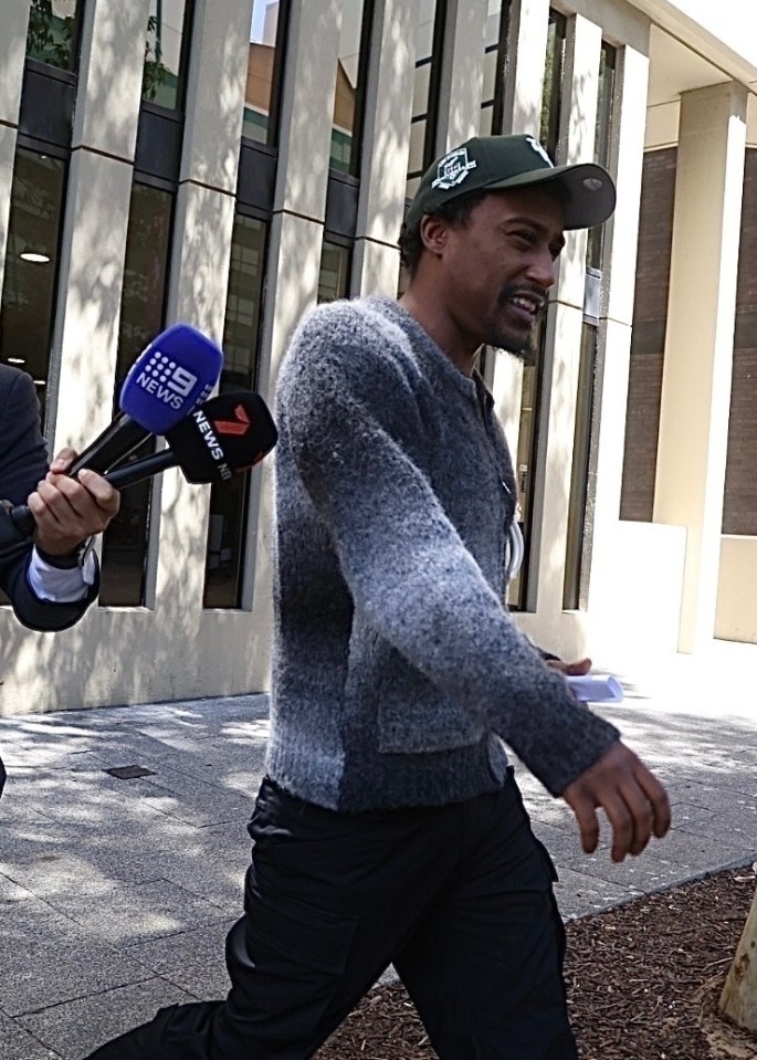 Yung Filly leaving a courthouse with reporters.