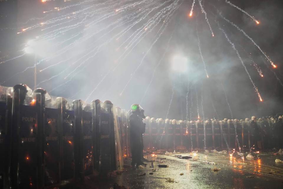 Fireworks exploding over riot police during a protest in Istanbul.