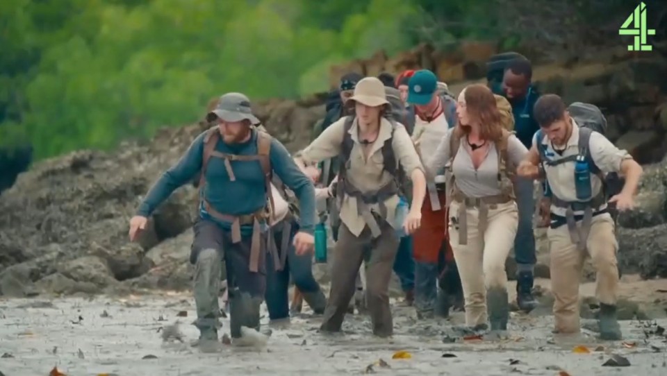 Contestants on Tempting Fortune wading through mud.