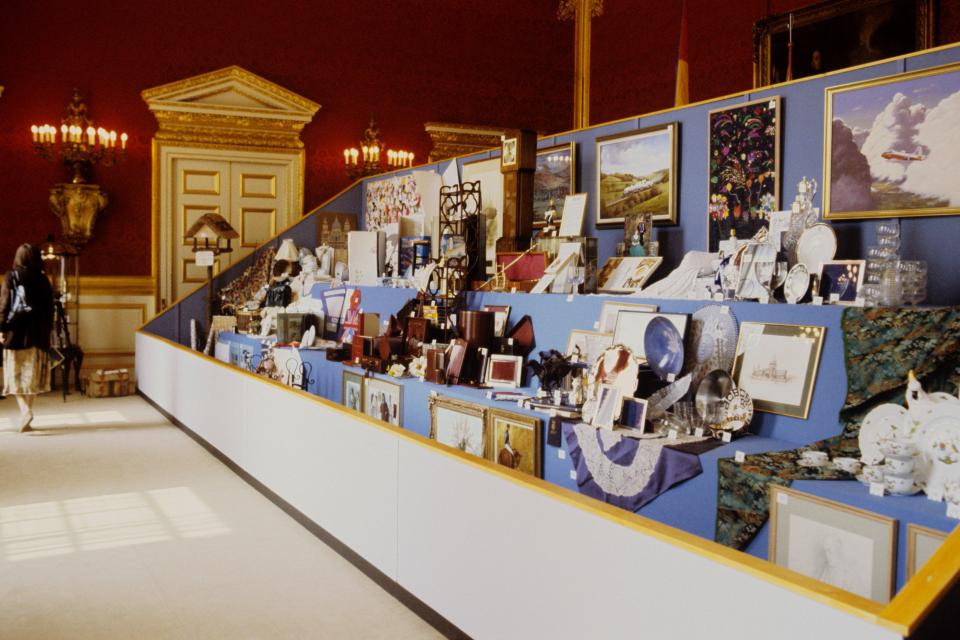 Wedding gifts displayed on tiered shelves.