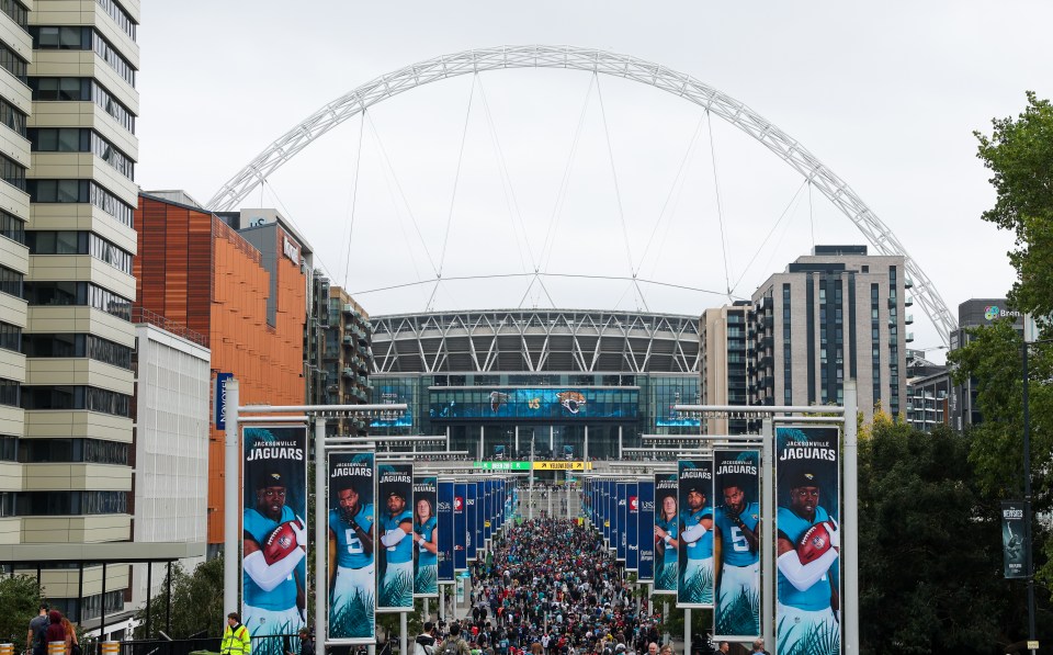 Fans walking toward Wembley Stadium before an NFL game.