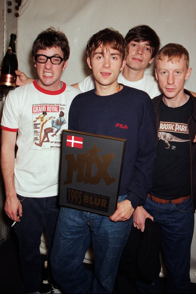 Blur band members at the MTV Europe Music Awards holding an award.