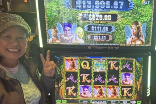 Woman winning at Pixies of the Forest slot machine.