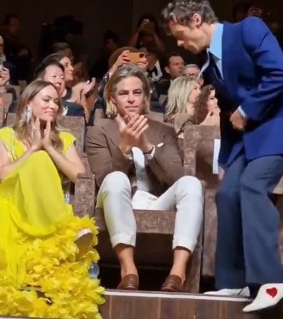 Harry Styles appearing to spit on Chris Pine at a film premiere.