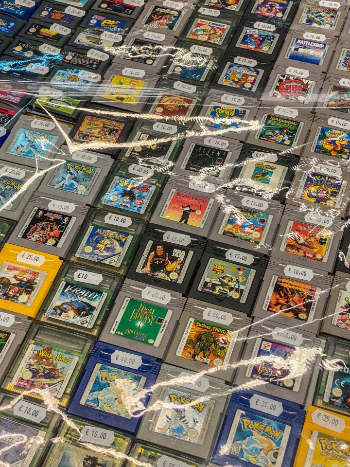 High-angle view of numerous vintage Game Boy cartridges for sale.