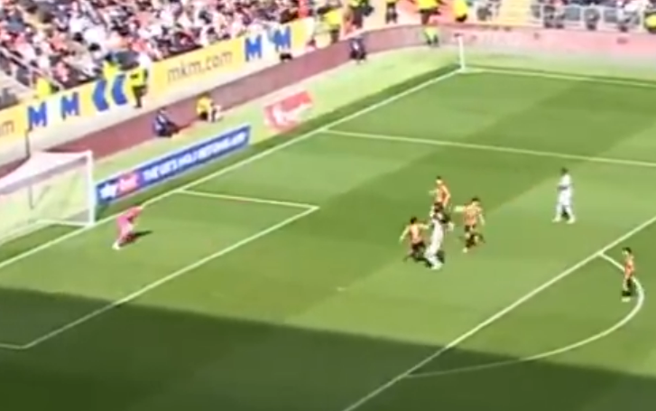 Soccer players near the goal during a game.