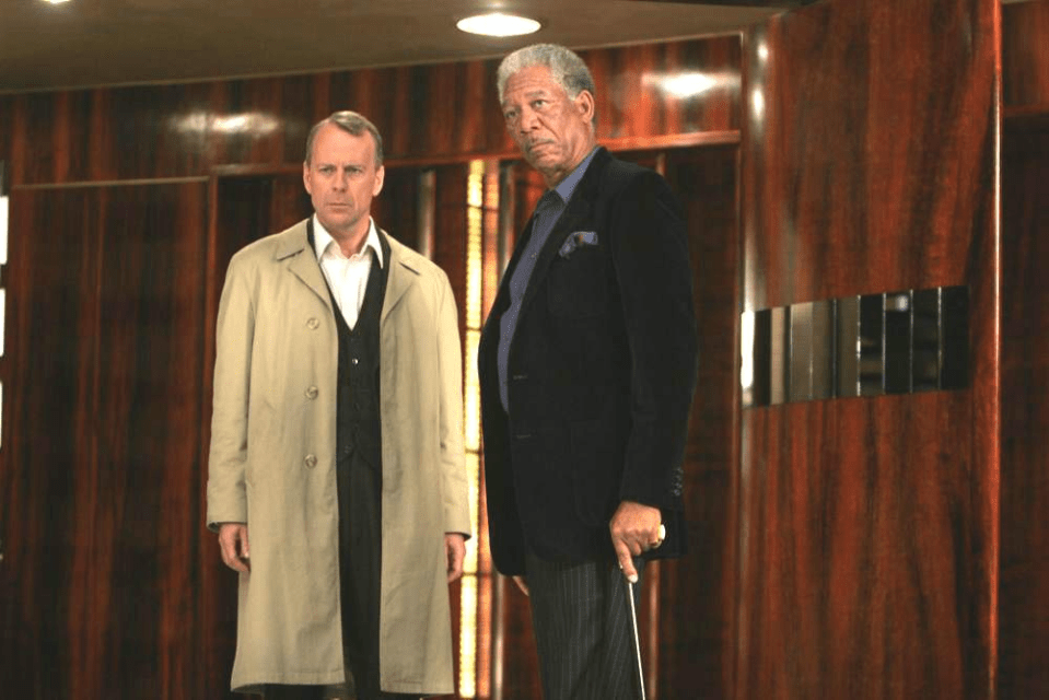 Two men standing in a hallway.