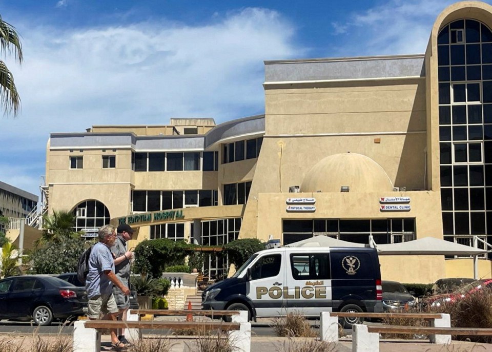 The Egyptian Hospital with a police van parked in front.