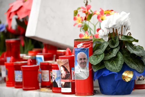 Candles and flowers at a memorial.