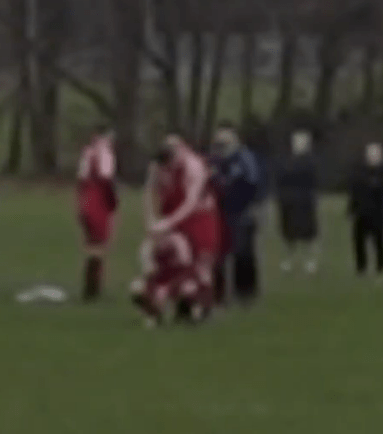 Blurry photo of a rugby scrum.
