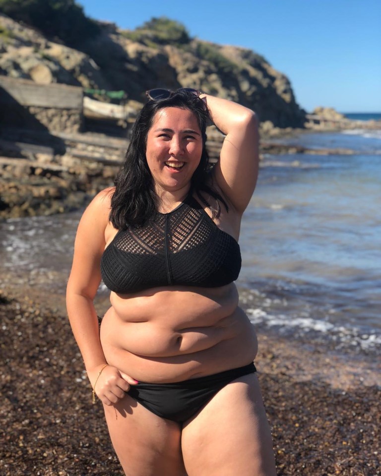 Woman in black bikini at the beach.