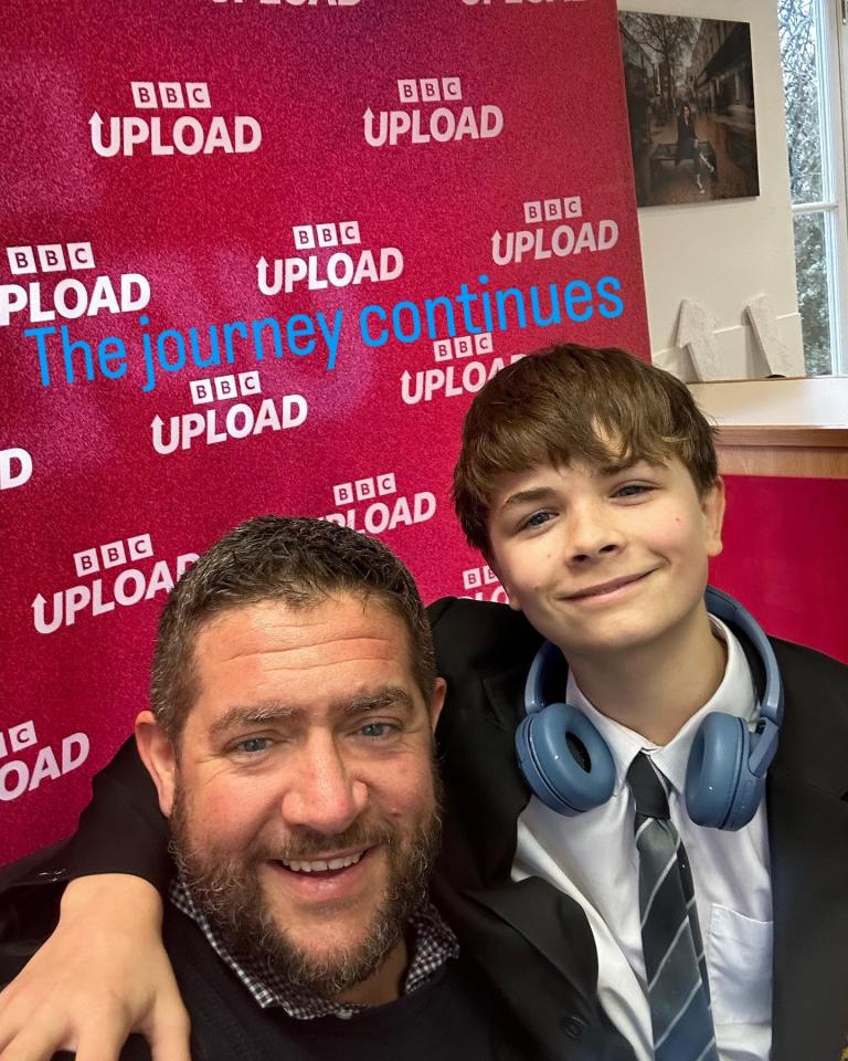 Photo of a man and a boy in front of a BBC Upload backdrop.