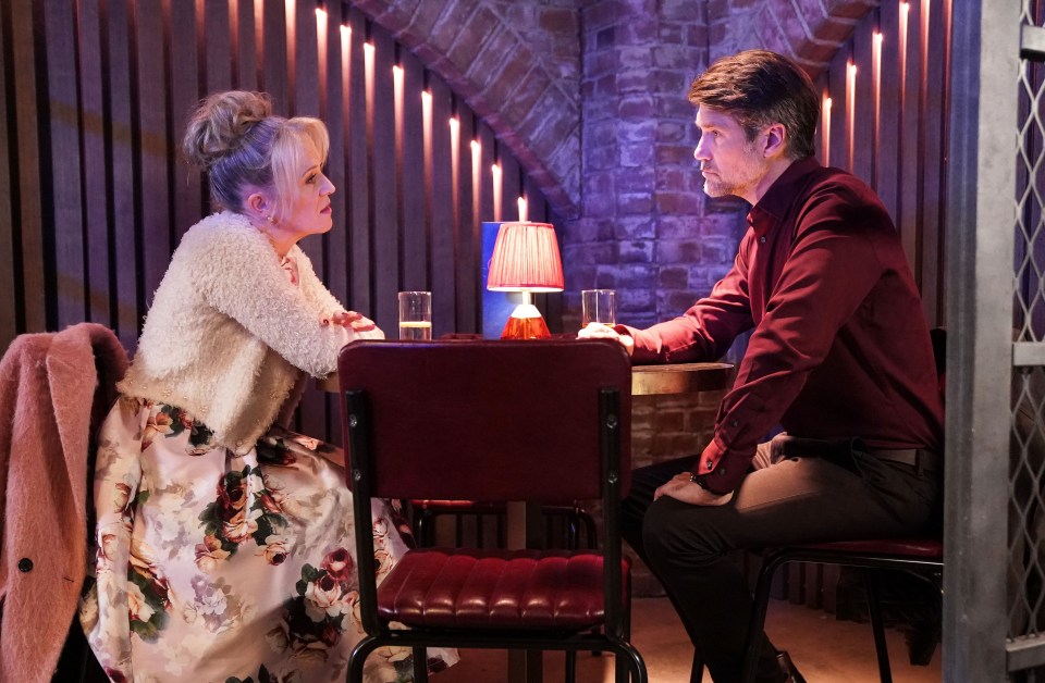 Linda Carter and Jeff having a conversation at a table.