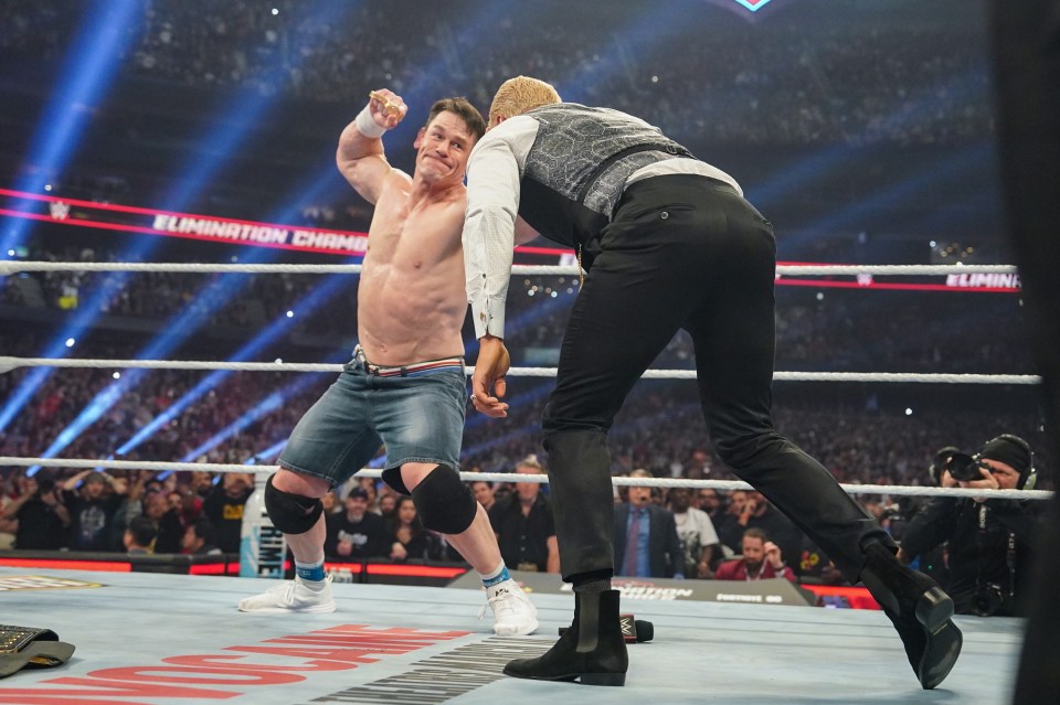 John Cena and Cody Rhodes wrestling in the WWE Elimination Chamber.
