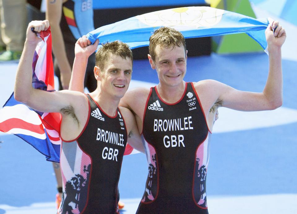 British brothers Alistair and Jonny Brownlee celebrate after a men's triathlon competition, Alistair with gold and Jonny with silver.