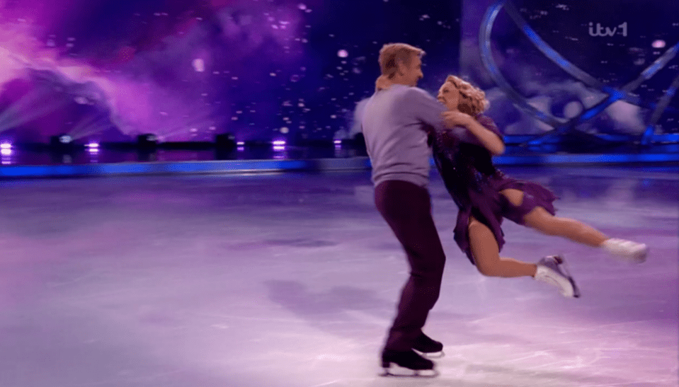 Ice skating pair performing a lift.