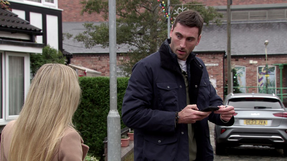 A man on a phone, taking a woman's car keys.