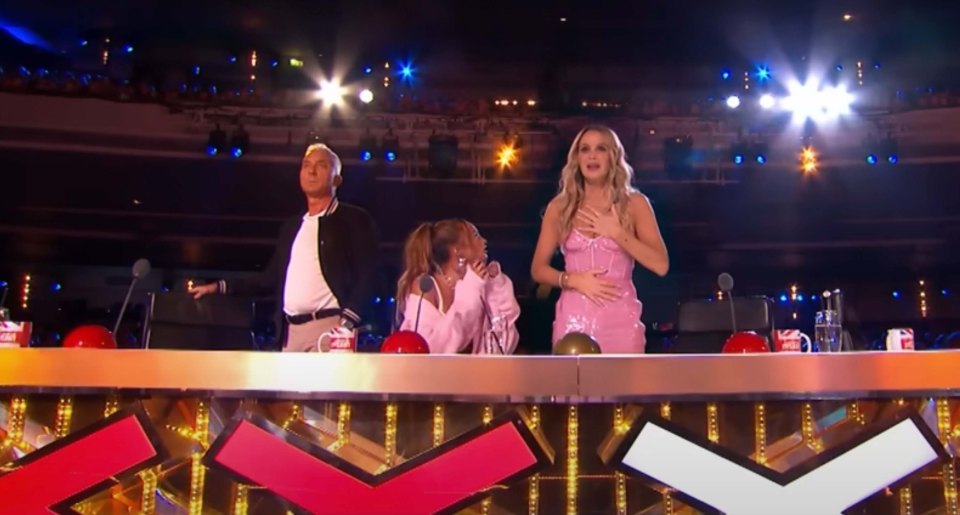 Three judges at a talent show judging a performance.