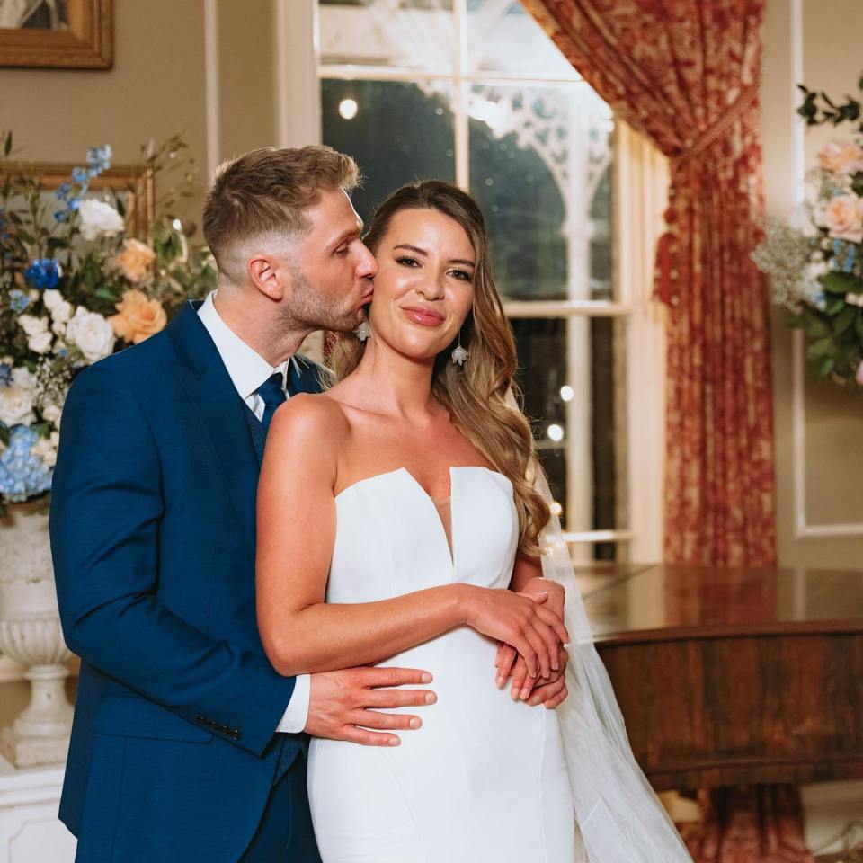 Laura Jayne Vaughan and Arthur Poremba embracing on their wedding day.