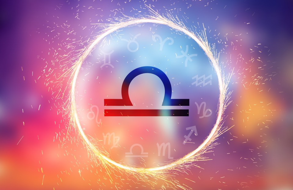 Libra zodiac symbol in a sparkling circle with other zodiac symbols.