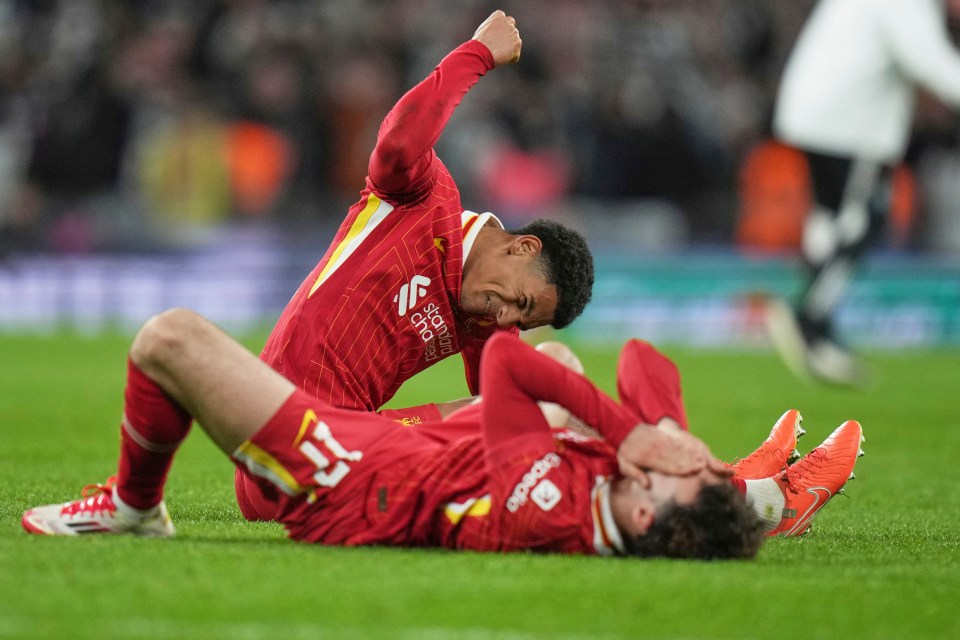 Liverpool players Jarell Quansah and Curtis Jones on the pitch after losing a soccer match.