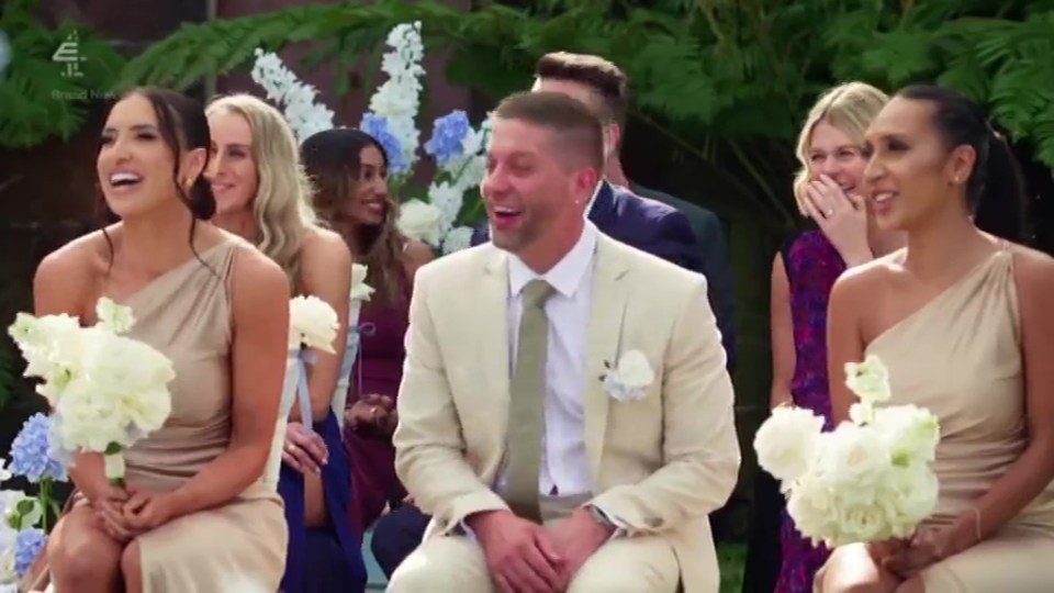 A groom and bridesmaids at an outdoor wedding.