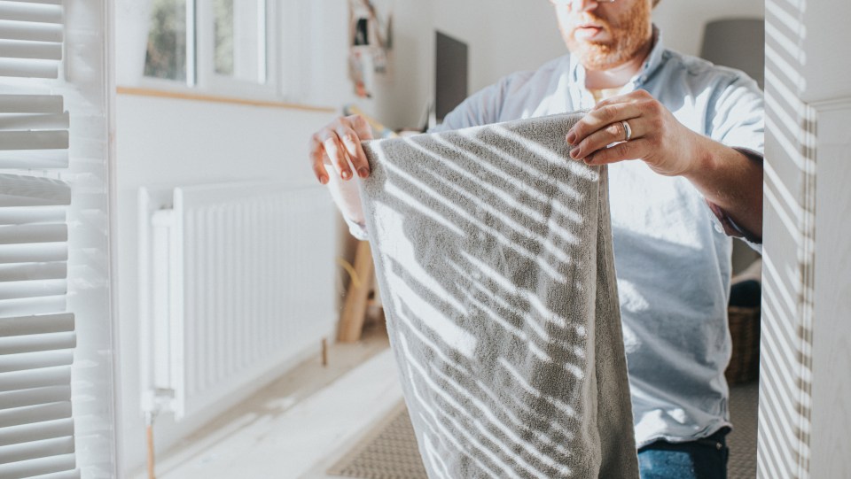 Man folding a towel.