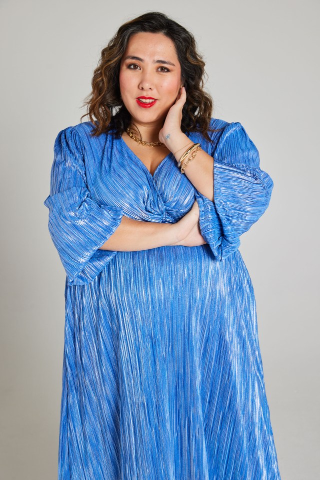 Woman in blue metallic pleated dress.