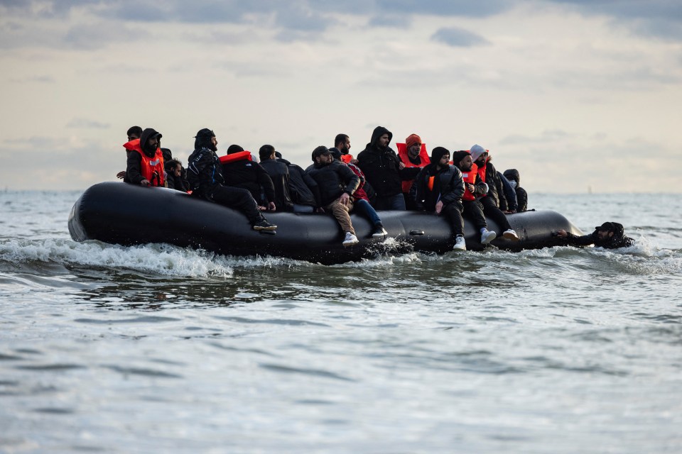 Migrants in a small boat attempting to cross the English Channel.