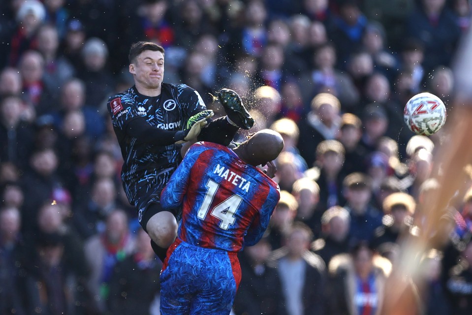 Millwall goalkeeper Liam Roberts karate kicks Crystal Palace's Jean-Philippe Mateta.