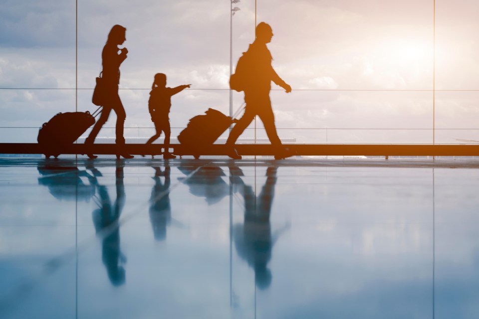 H4BF85 Family at the airport with sunset